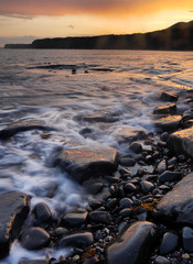 Kimmeridge Bay Dorset tides and rocks at sunset