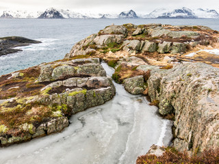 Fototapeta na wymiar Ice in winter at rocky west coast of Austvagoy and Gimsoystraumen, Lofoten islands, Nordland, Norway