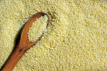 Couscous close up with a wooden spoon