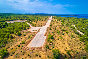 Fototapeta na wymiar Abandoned and destroyed airport runway in Zadar Sepurine aerial view