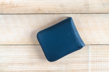 modern black leather wallet on wooden table background. wealth, saving, money, finance and investment concept.