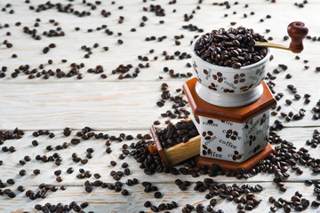 Fototapeta na wymiar Coffee grinder handle close up on a background of coffee grains
