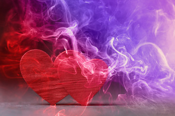 Two red hearts in colored smoke