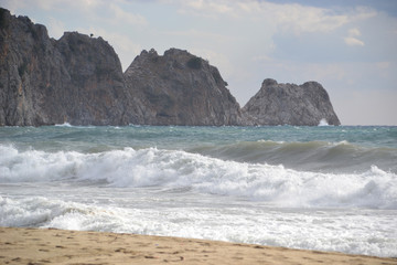 Fototapeta na wymiar Beautiful bay of Cleopatra beach in Alanya Turkey, windy day, big waves on the sea