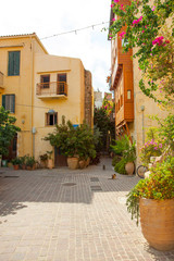 Fototapeta na wymiar Romantic old courtyard and buildings and cobblestone streets of Crete island, Greece