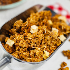 Scoop Full of Organic Apple Cinnamon Granola. Selective focus.