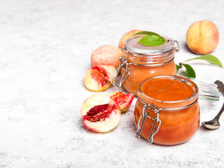 Homemade peach jam with organic fruit. Sweet preserves on a light background, , copy space