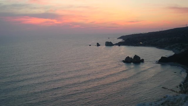 Extremely still and blue Mediterranean sea water on the background of wonderful colorful sunset landscape