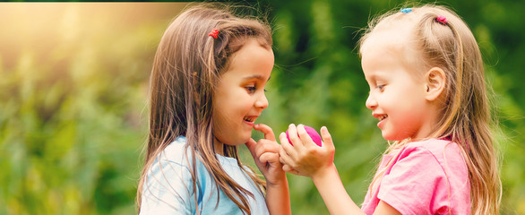 Outdoor portrait of two embracing cute little girls