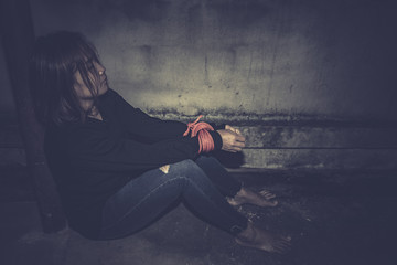 Asian hostage woman Bound with rope at night scene,The thieves kidnapped for ransom,thailand people