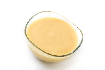 Bowl of homemade vanilla custard isolated on white background

