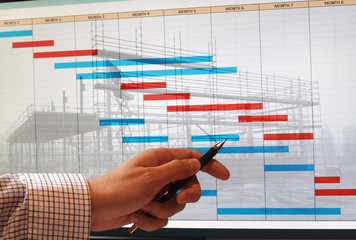 engineer studying time chart gantt diagram over building construction image