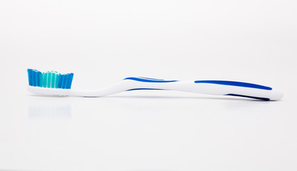 toothbrush with toothpaste on white background