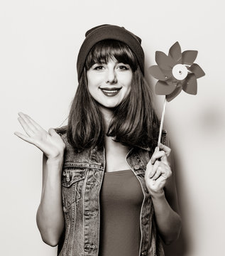 Portrait of young style hipster girl with pinwheel . Image in black and white color style