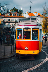 Vintage old red tram in the city center of Lisbon. City touristic landmarks of Lisboa Lissabon, Portugal
