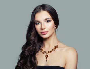Young woman fashion model with long hair and amber necklace, portrait