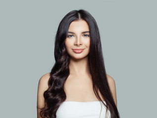 Happy woman with curly and straight hair after using a hair straightener. Hair care concept
