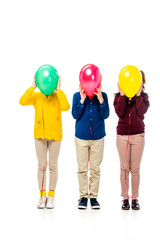 kids hiding face behind colorful balloons isolated on white