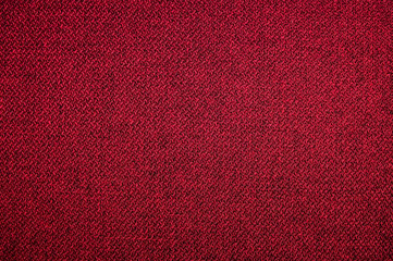 Fototapeta premium Textured background surface of textile upholstery furniture close-up. red Color fabric structure