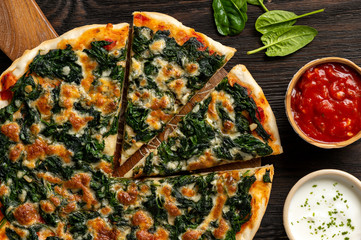 Homemade spinach pizza with mozzarella.