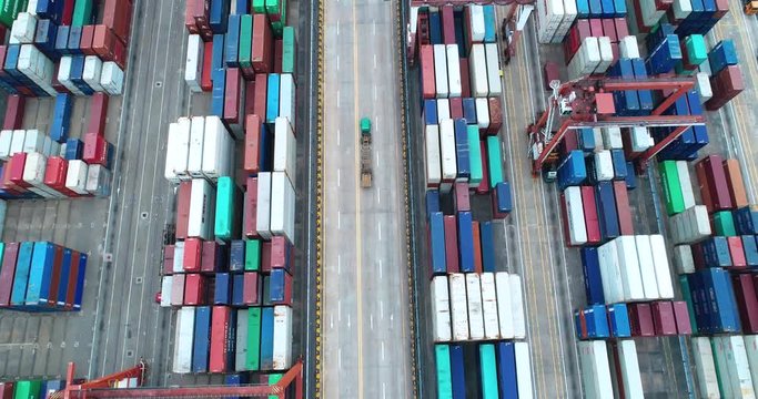 4k,drone shoot of cargo terminal in shenzhen china, containers deposited neatly,trucks moving on road,concept:international transport  and storage