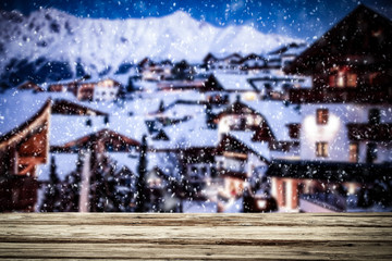 Old wooden table in the snowy mountains. Alps with a free place for an advertising product  
