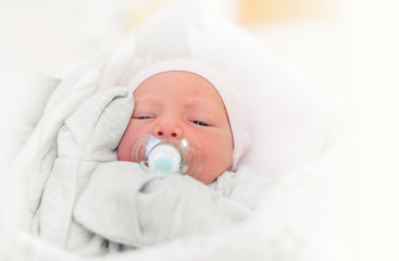 Baby girl close-up in a baby cot.