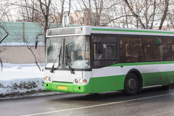 bus moves in the winter along the street