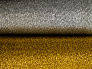 Gold and silver sewing threads background - close-up	