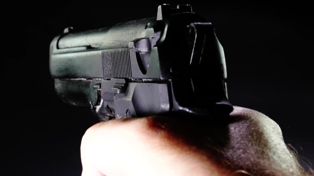 POV of shooter pointing 9 mm pistol