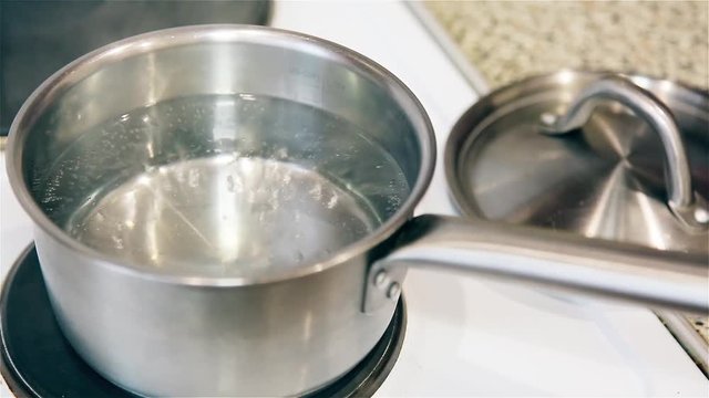 Boiling water in an aluminum pot on the stove HD 1920