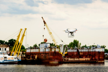 Fototapeta na wymiar Drone with camera flying on container cargo ship at shipping port. double exposure