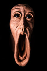 image of a panicked face screaming with bulging eyes, terrifying face. Face of fear very...
