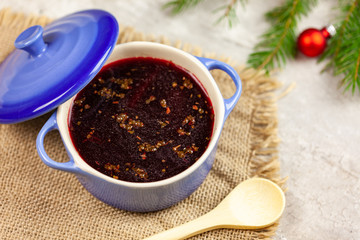 Christmas borscht in a pot with Christmas decorations in the background