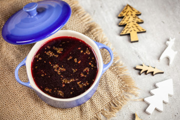 Christmas borscht in a pot with Christmas decorations in the background