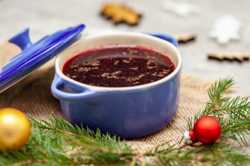 Christmas borscht in a pot with Christmas decorations in the background
