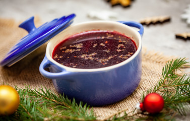 Christmas borscht in a pot with Christmas decorations in the background