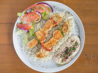 Greek Mediterranean chicken kabobs with hummus.