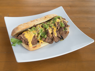 Philly cheesesteak with melted cheese.