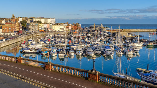 The impressive and historic Royal Harbour of Ramsgate, Kent, Uk, full of leaisure and fishing boats of all sizes and the colourful facade of the historic buildings along the marina promenade