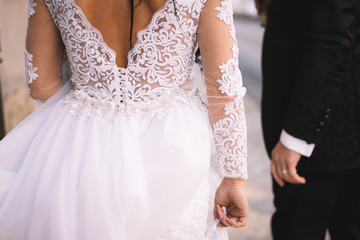 bride and groom from behind captured in the streets