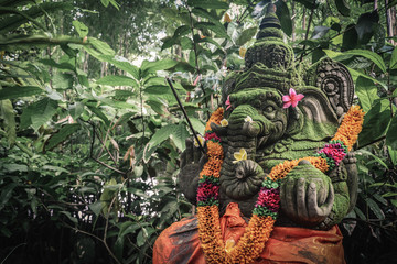 Stone Ganesha statue with the incense sticks © tashka2000