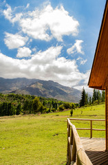 summer view of the mountains. Foreground forest. in the distance are houses. edging trees. Sunny summer in the mountains.