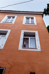 kitten looking from the window of a low-rise building