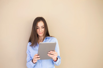 Portrait of a self-confident woman with a tablet in her hand