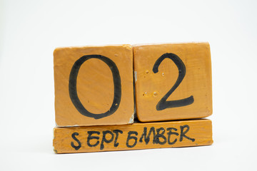 september 2nd. Day 2 of month, handmade wood calendar isolated on white background. autumn month, day of the year concept