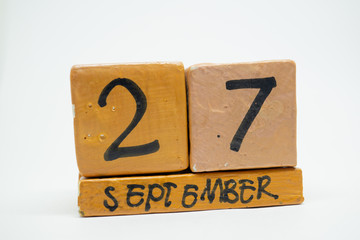 september 27th. Day 27 of month, handmade wood calendar isolated on white background. autumn month, day of the year concept