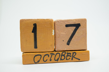 october 17th. Day 17 of month, handmade wood calendar isolated on white background. autumn month, day of the year concept