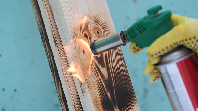 Fire flame concept Burning wood burner burns wood planking fire flames wood texture worker at constructing tool concept 