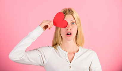 Valentines day concept. How to feel less lonely on valentines day. Being single on valentines issues. How to fight valentines day loneliness. Girl hold heart love symbol over pink background